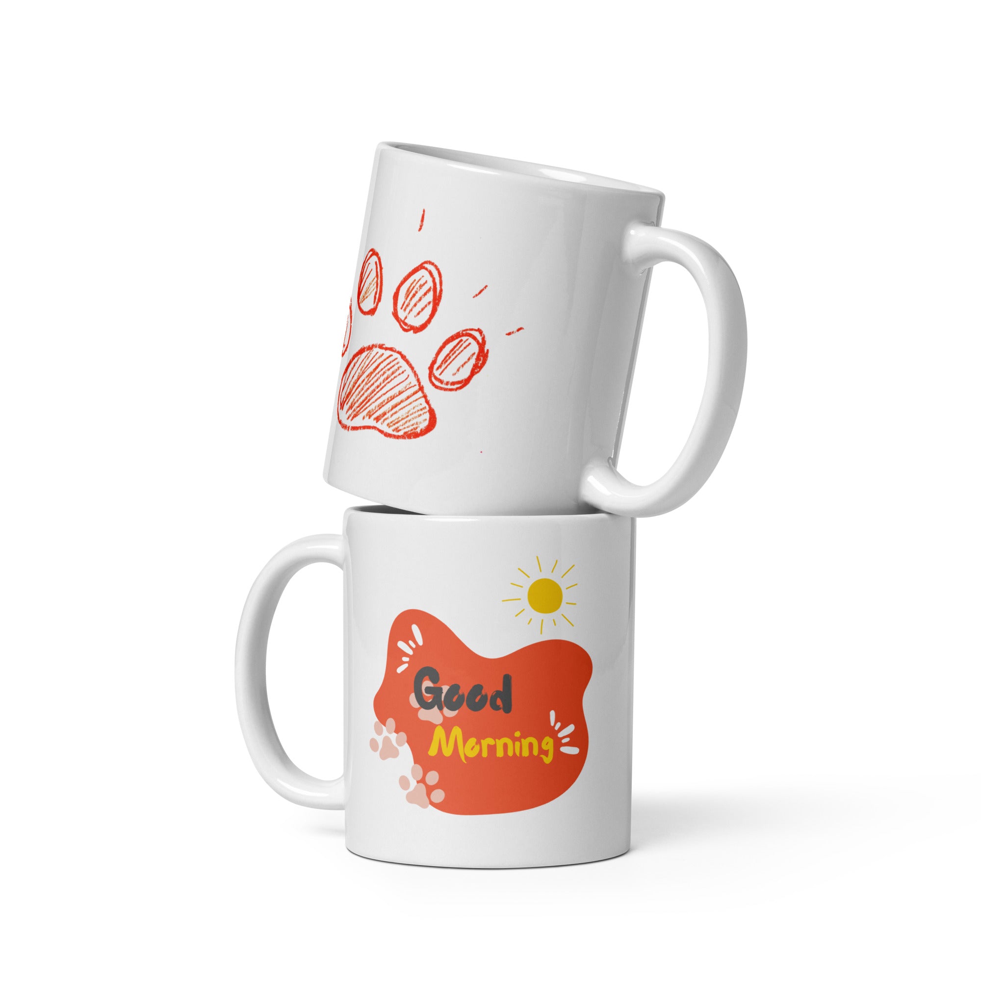 A double-sided ceramic coffee mug with an orange paw print design and 'Good Morning' message on one side, and a plain background on the other.