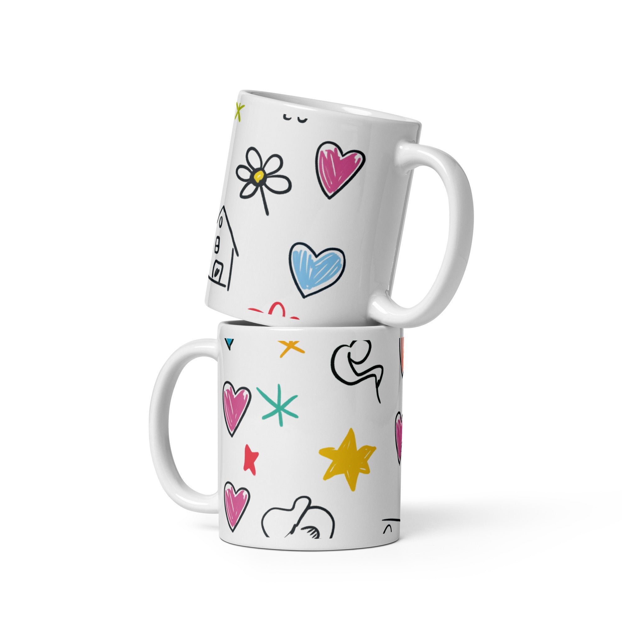 Two white mugs with colorful doodles stacked on a white background