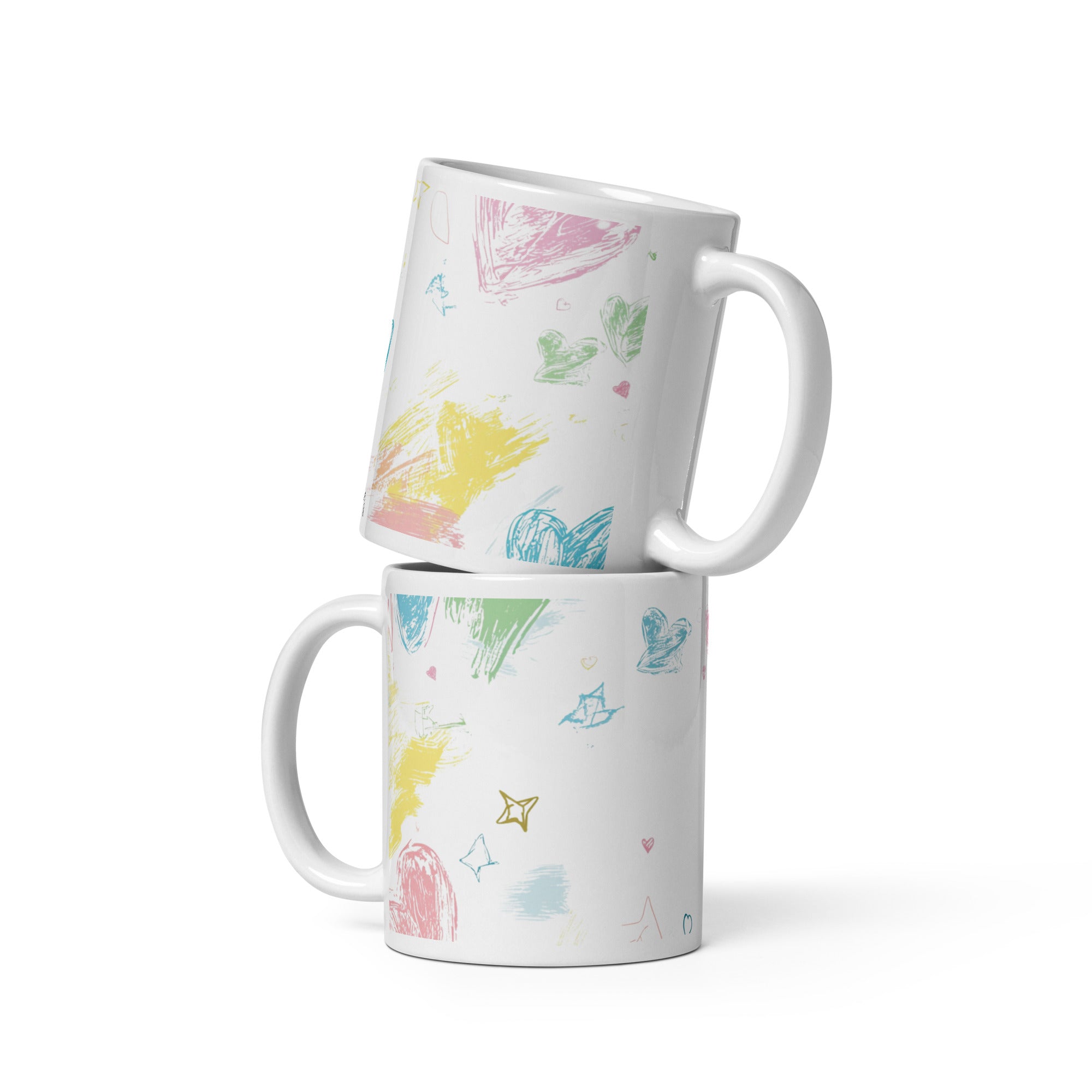 Two white mugs with colorful abstract patterns stacked on a white background
