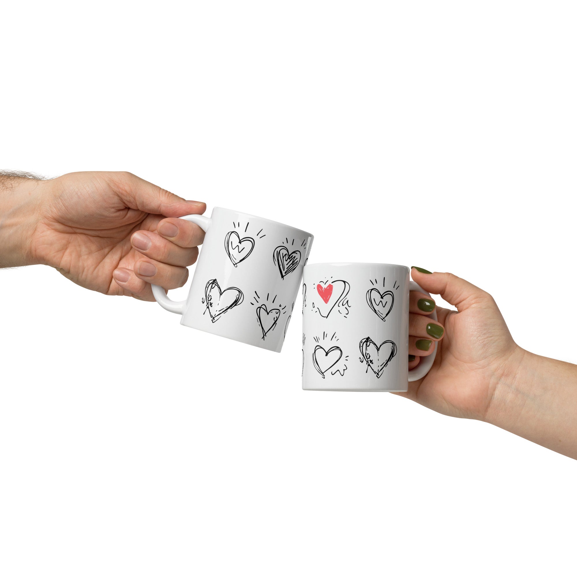 Two white mugs with heart designs held by two hands on a white background