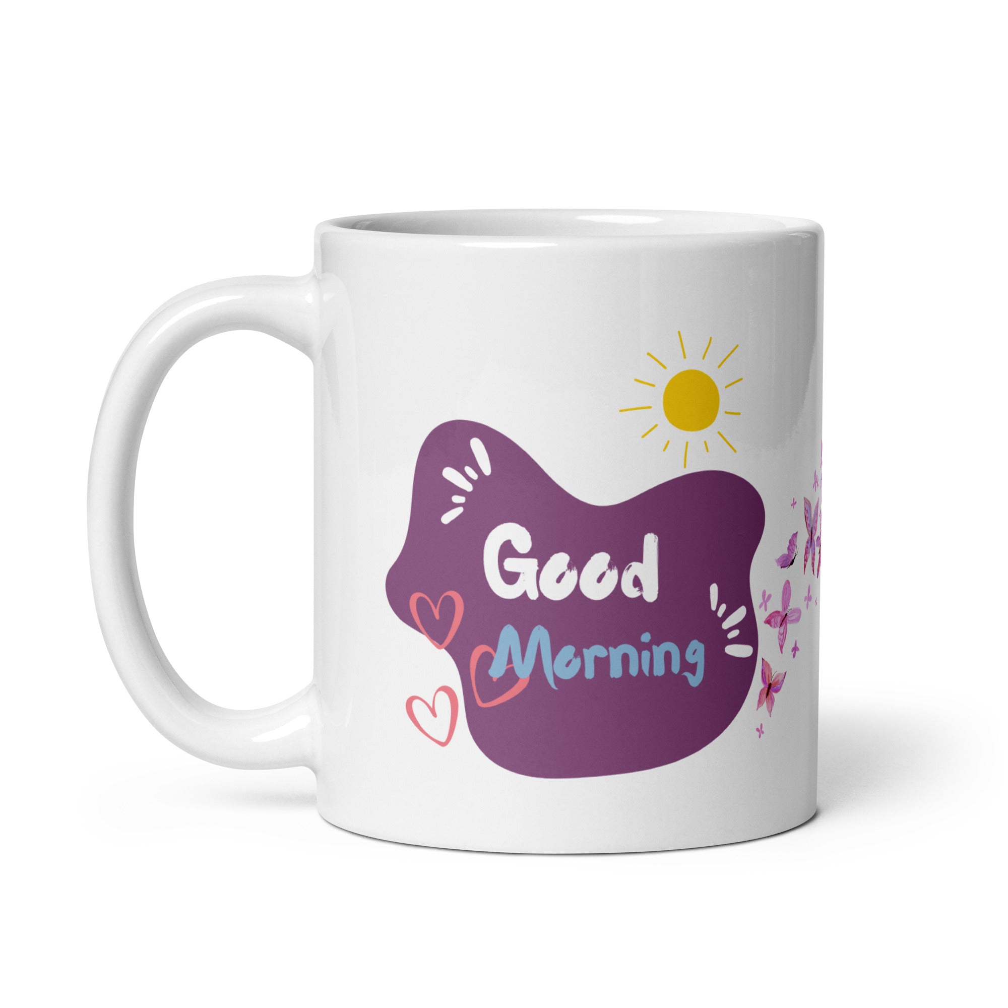 A ceramic coffee cup with a pink butterfly and hearts design, and a text message that reads 'Good Morning'.