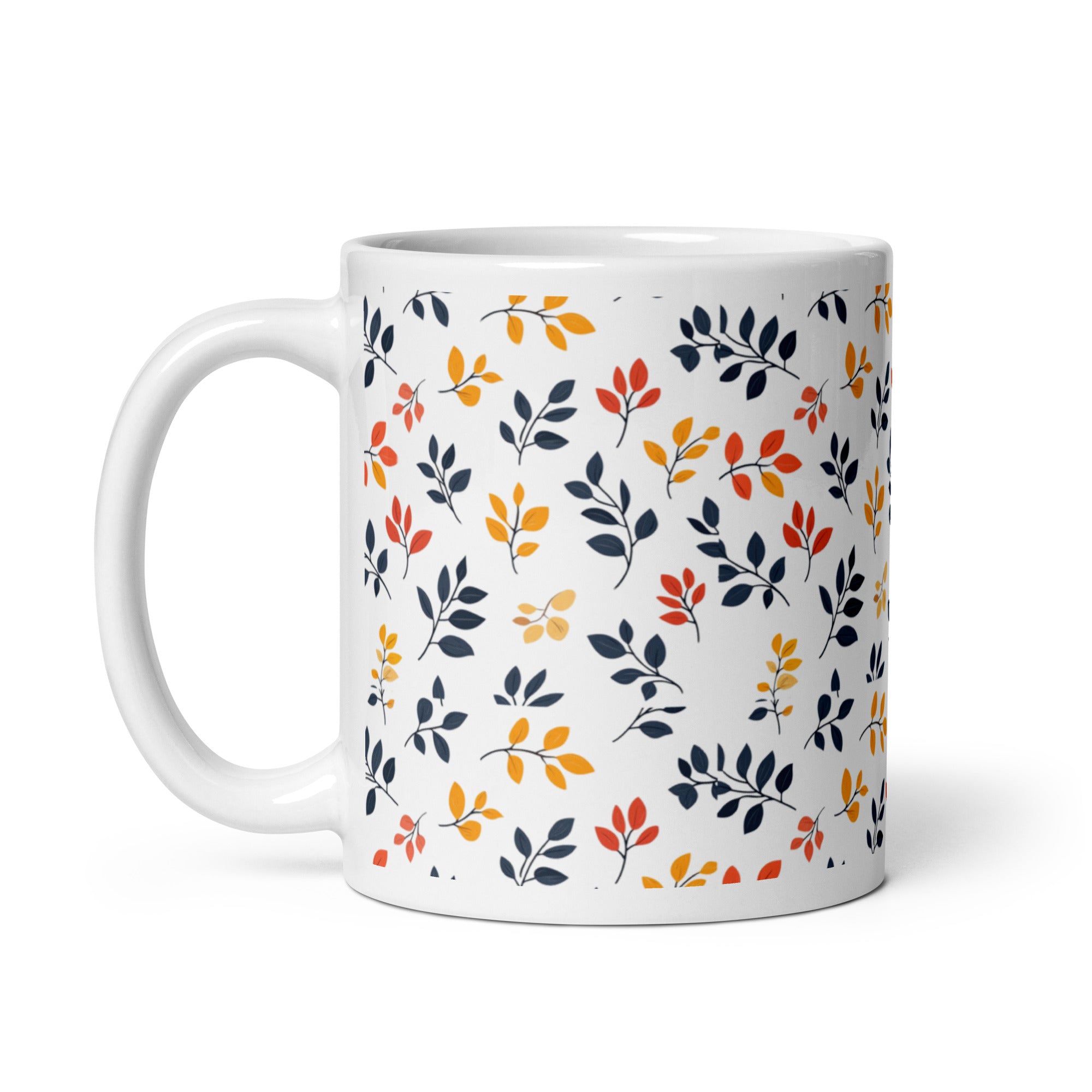 A set of two ceramic coffee mugs with a floral and autumn leaf design on a white background, one mug is filled with a liquid, possibly coffee or tea.