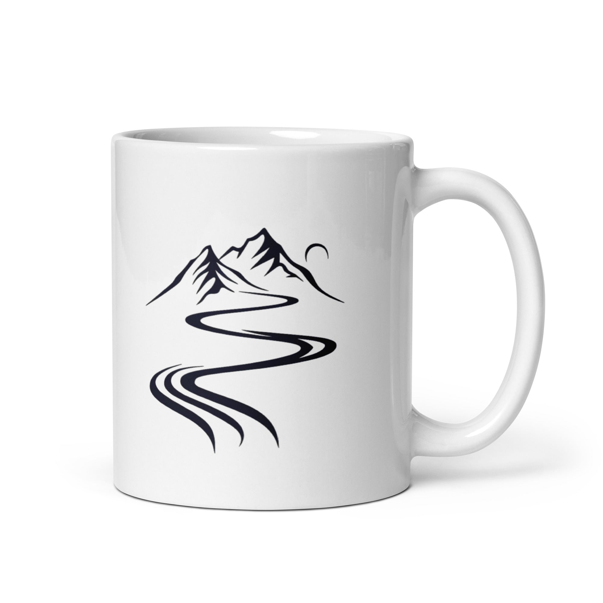 A glossy white ceramic mug with a mountain path design and a text 'GOOD MORNING' on the other side, placed against a plain background.