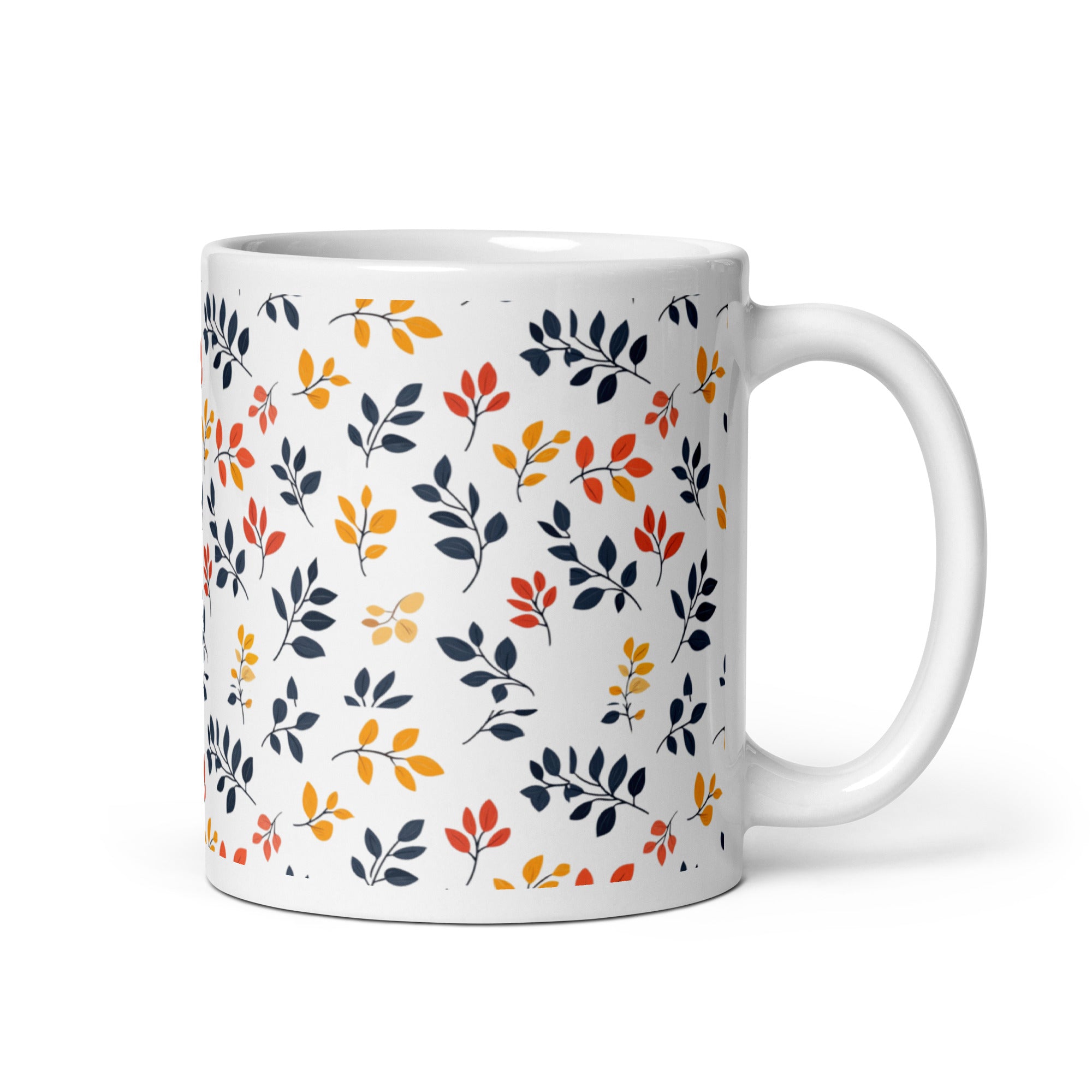 A set of two ceramic coffee mugs with a floral and autumn leaf design on a white background, one mug is filled with a liquid, possibly coffee or tea.