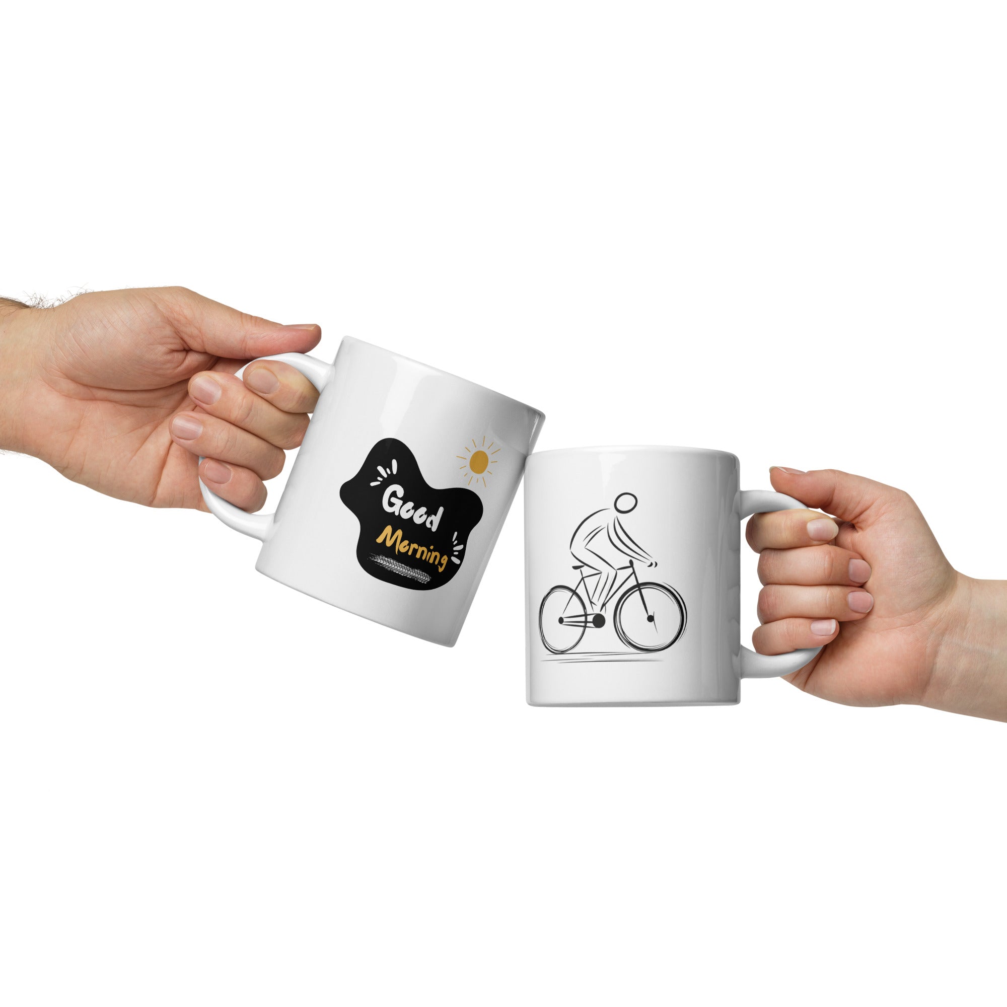 Two white ceramic mugs, one with a minimalist black bicycle design and the other featuring a 'Good Morning' message with a yellow sun accent, both with bold black and yellow prints.