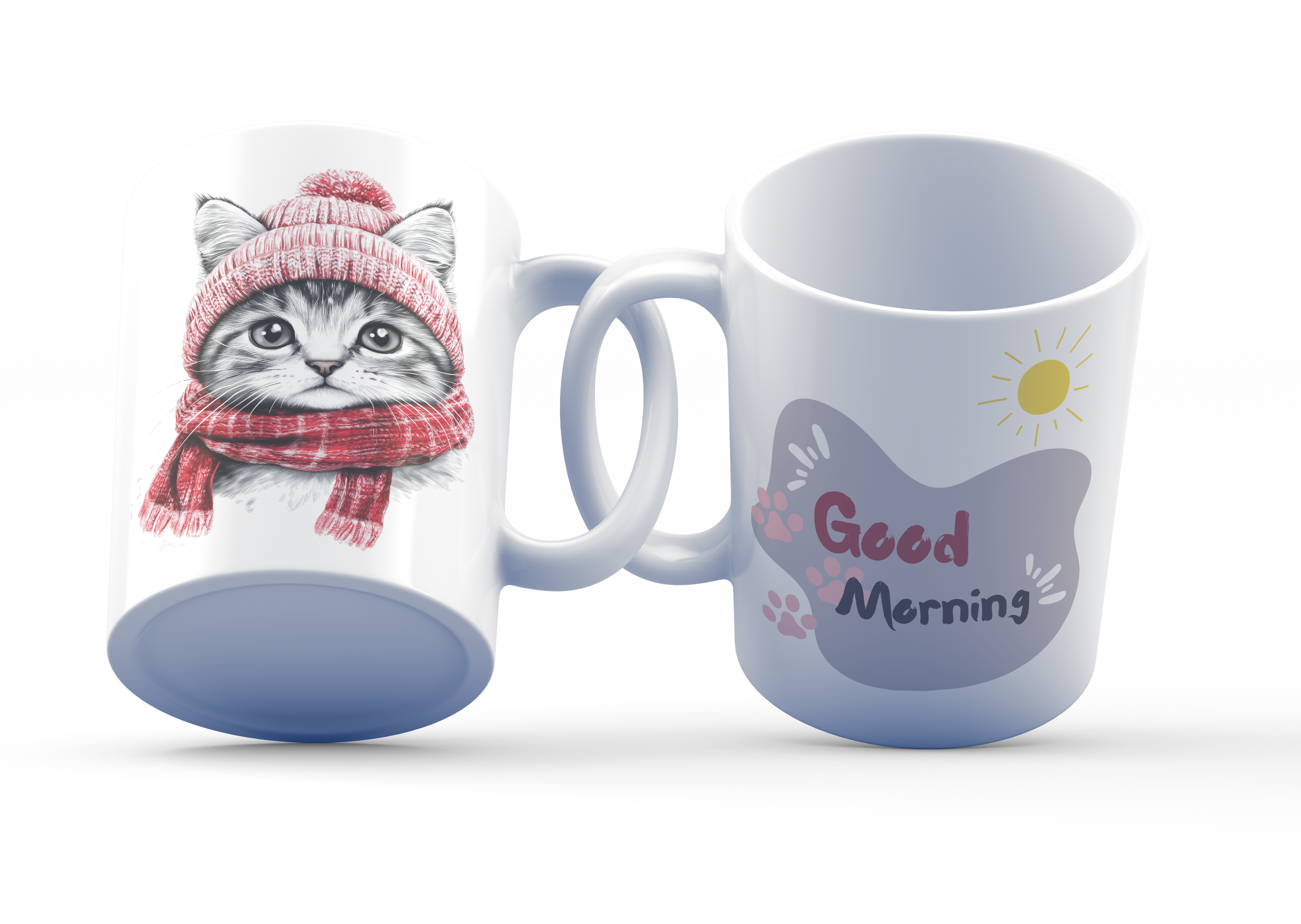 A white ceramic coffee cup with a cozy cat design, featuring a black-and-white illustration of a cat wearing a red knit hat and scarf on one side, and a 'Good Morning' message with a sun and paw prints on the other side.