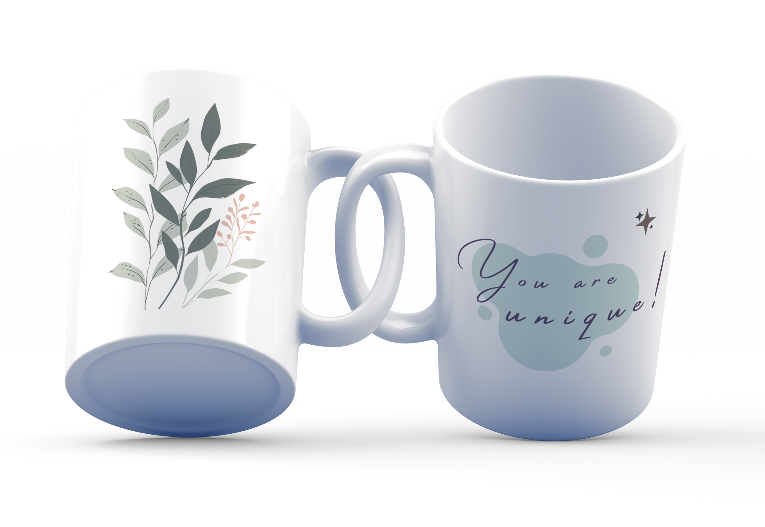 Two white ceramic mugs, one with a botanical leaves design and one with the text 'You are unique!' printed on it, displayed side by side.